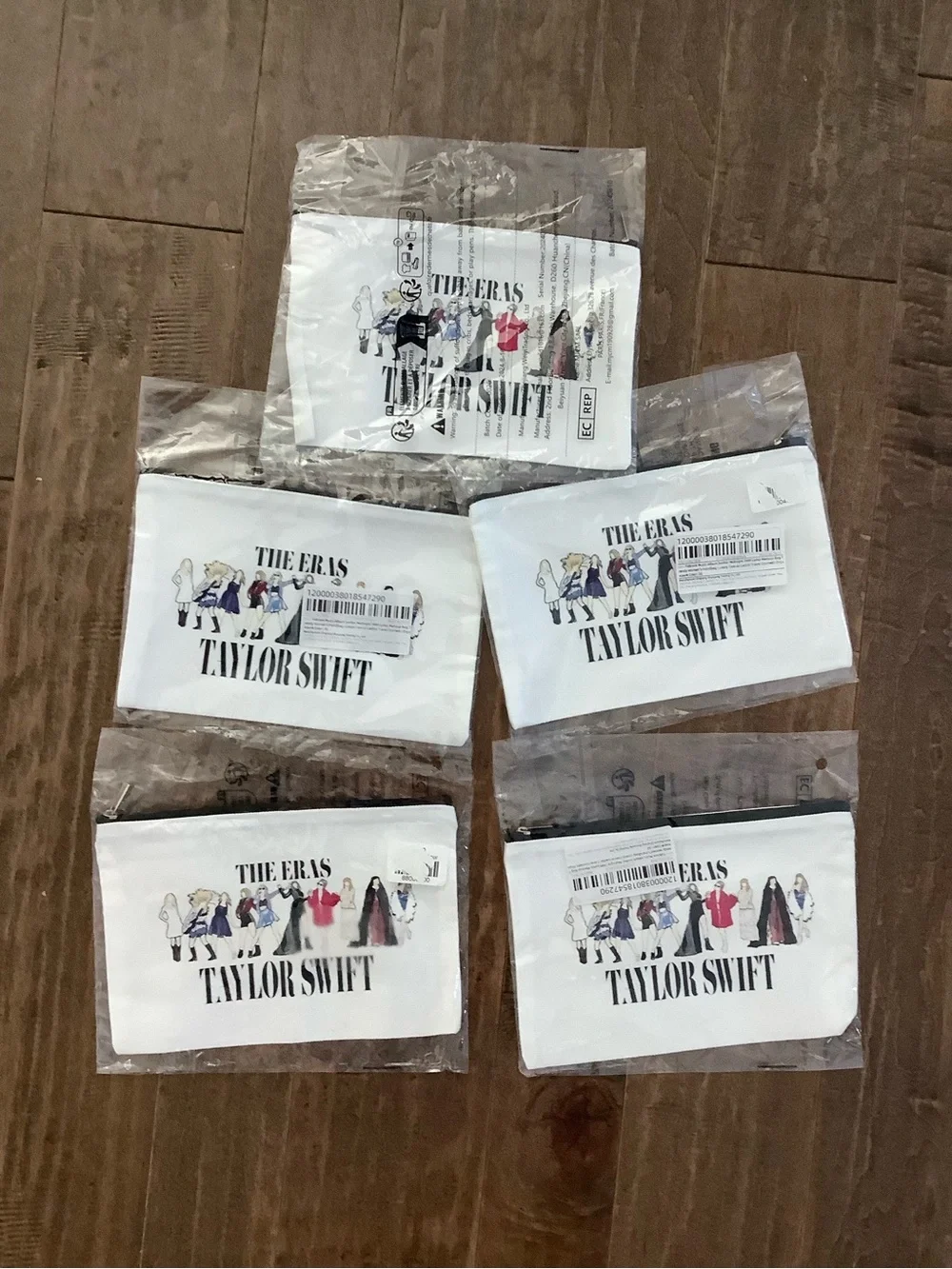 Five Taylor Swift White 'The Eras' Zip Pouches with Multicolor Illustration